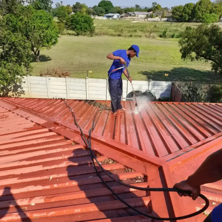 High-pressure water cleaning of a tiled roof in Cape Town for moss, dirt, and debris removal
