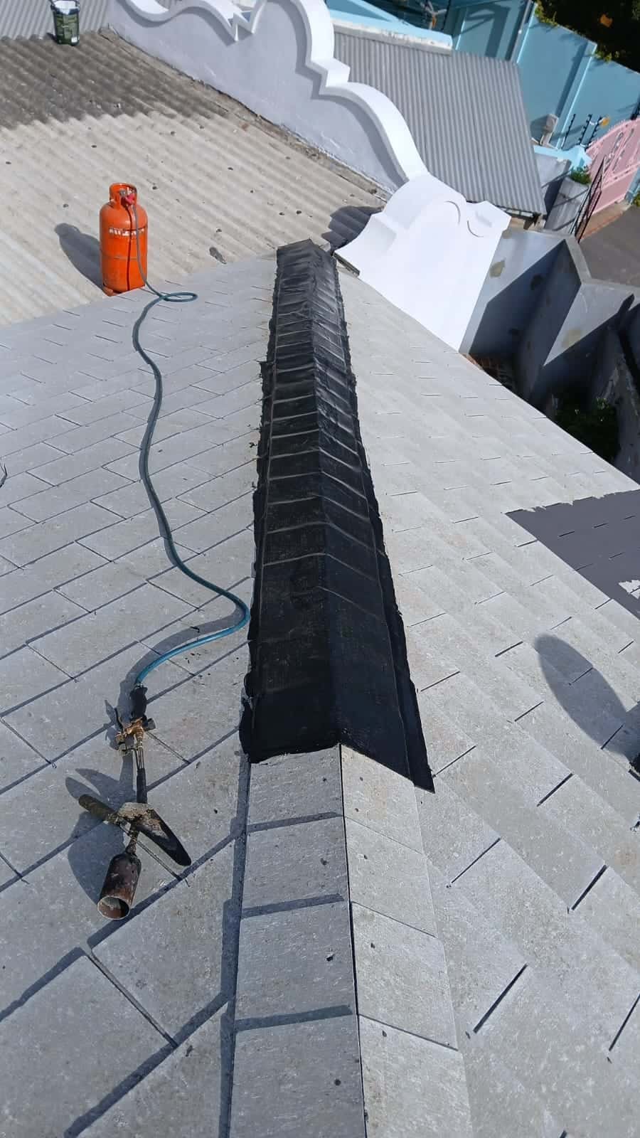 Torch-on waterproofing applied along roof ridge in Green Point by Wilcote Cape Town.