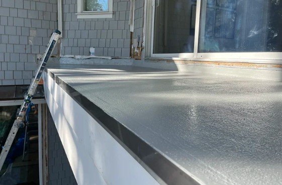 Waterproofing balcony slab with protective coating for leak prevention.