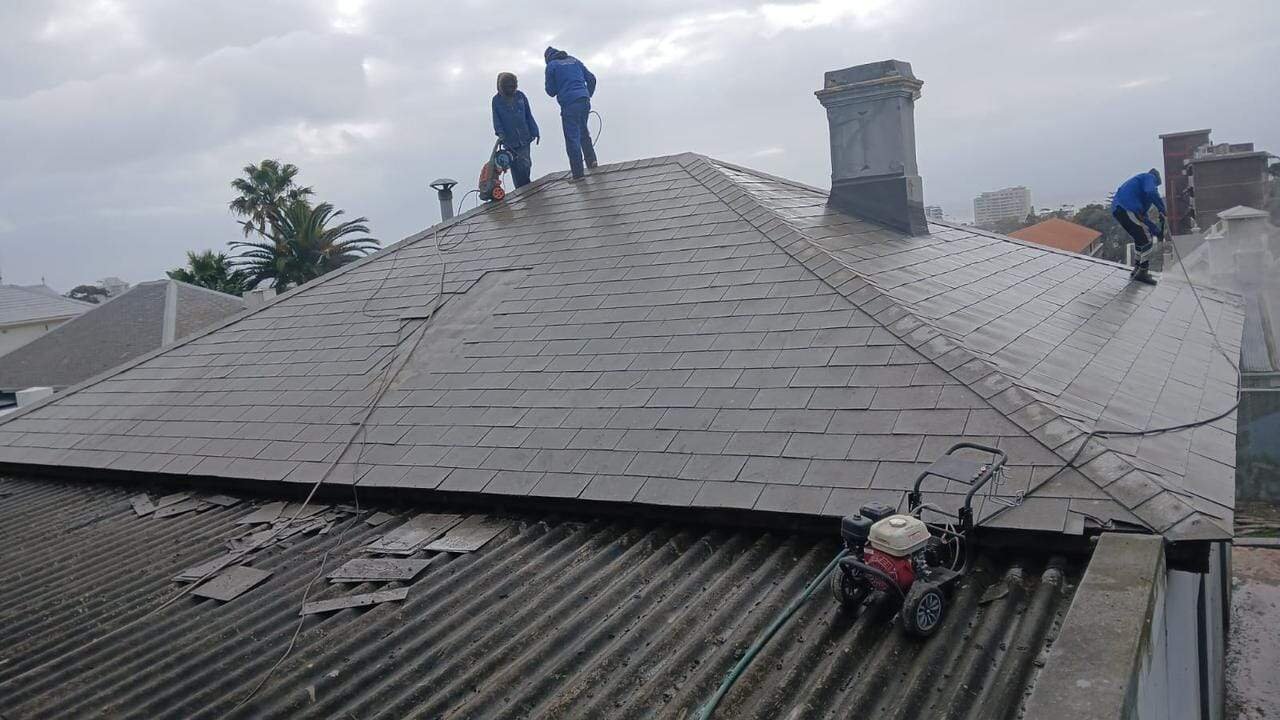 Wilcote Cape Town team high-pressure cleaning roof in Green Point before waterproofing and painting.