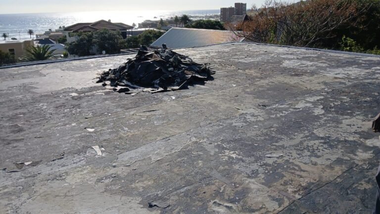 Old torch-on membrane peeling and breaking apart – roof at risk of leaks.
