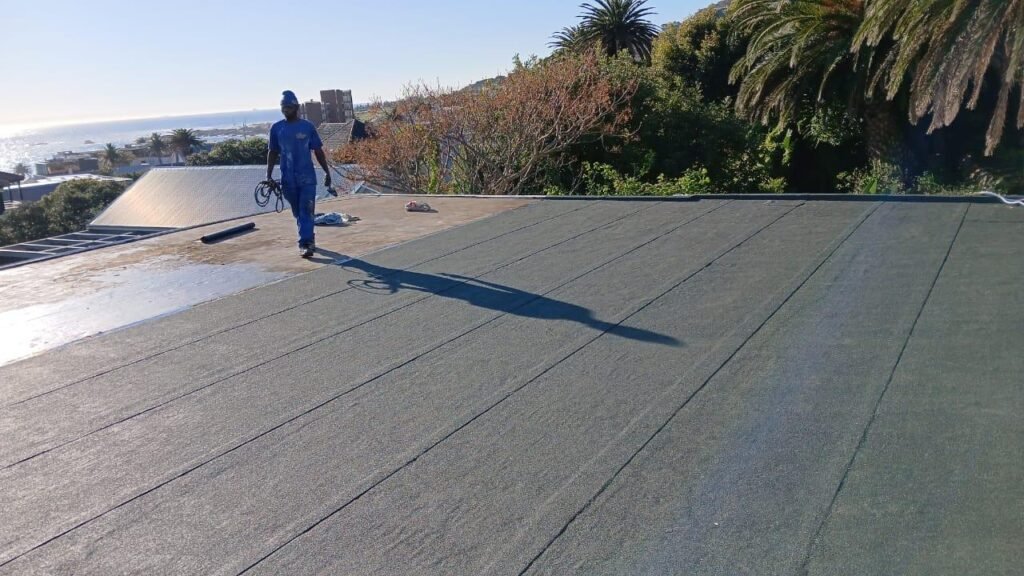 Wilcote team applying new torch-on waterproofing with heat-sealed seams.